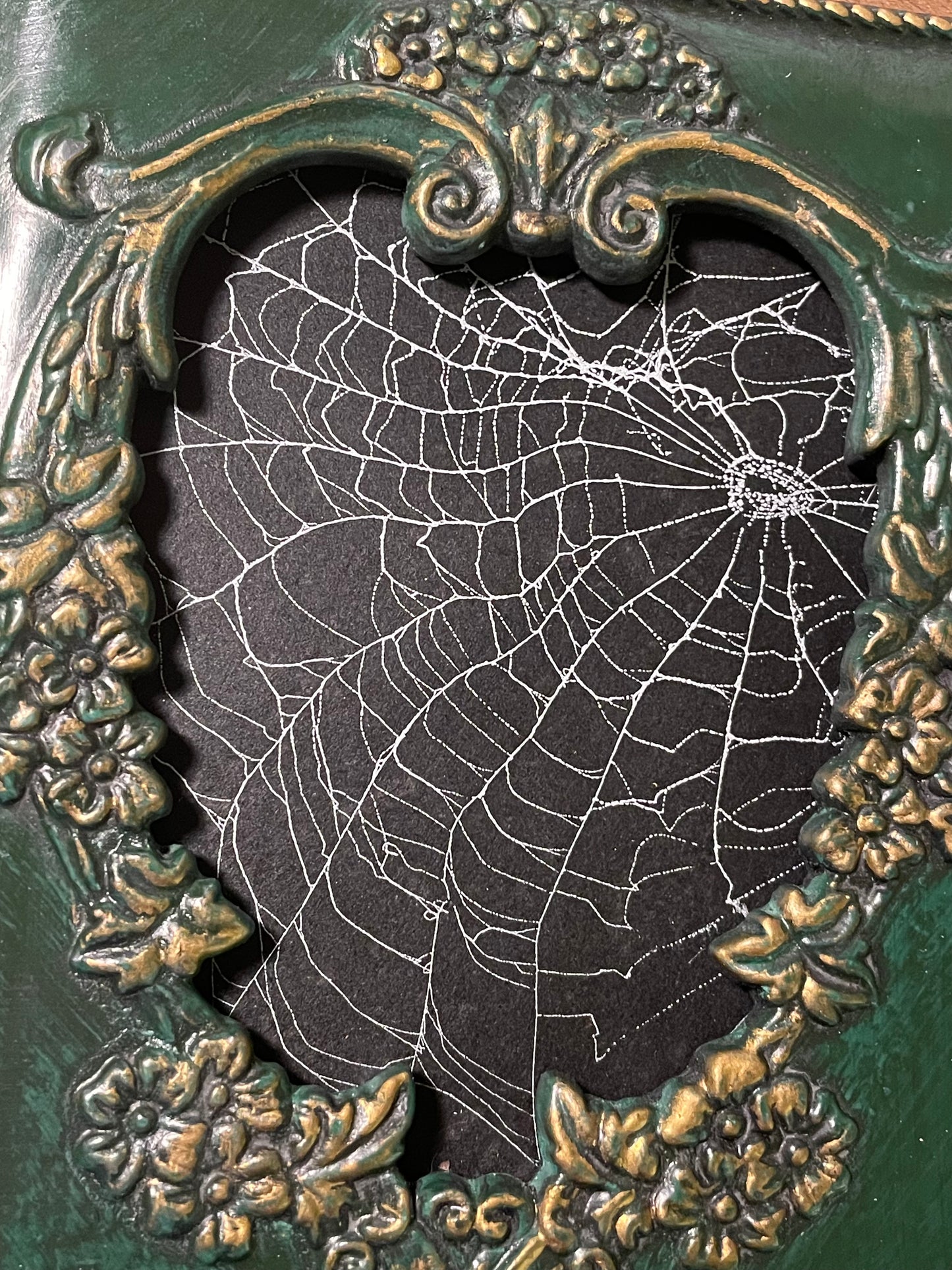 Natural preserved spider web in vintage green frame